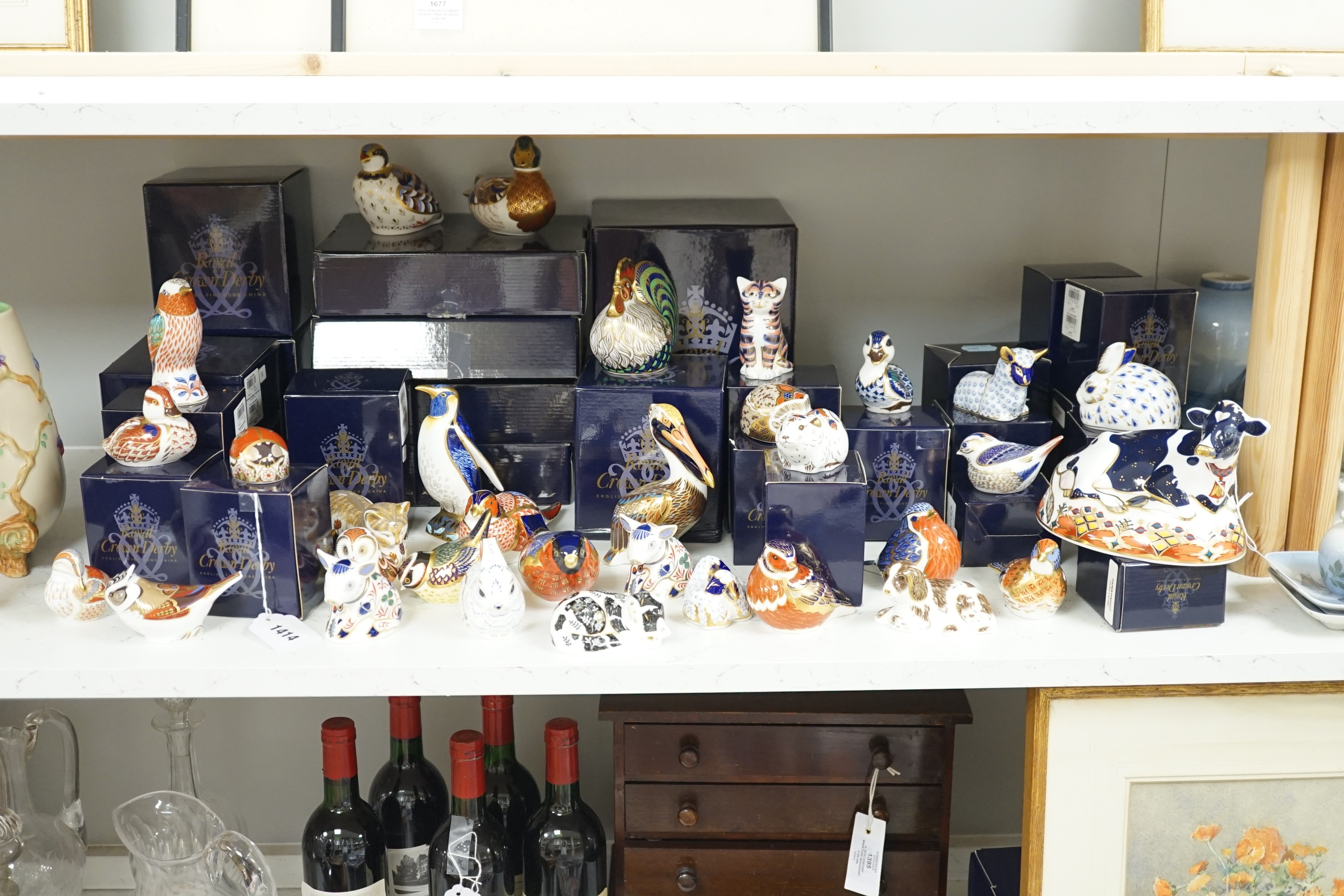 Approximately thirty-two Royal Crown Derby Imari porcelain paperweights, all but two with original boxes and mostly gold bottoms